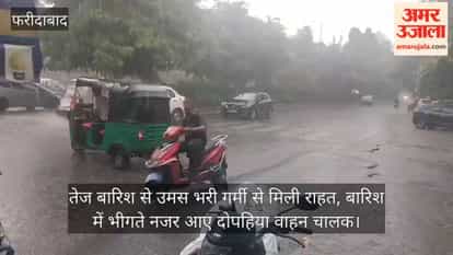 Heavy rain brings relief from the humid heat; two-wheeler riders seen getting drenched.
