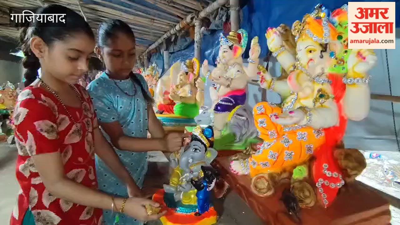 Artists Mamata and Karishma putting finishing touches on idol of Lord Ganesha